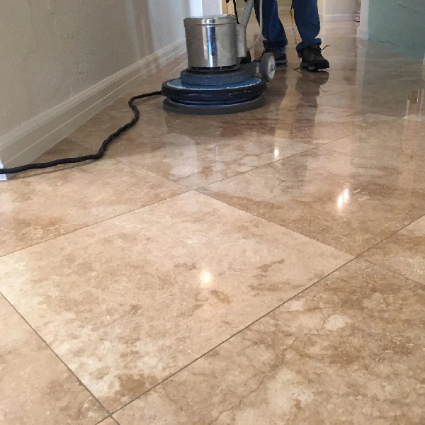 Polishing reflective marble tiles with a professional floor buffer.